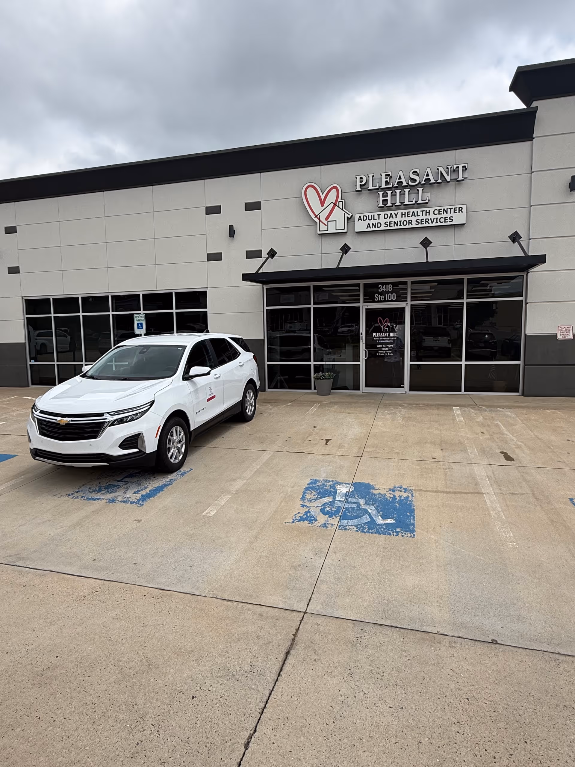 Exterior view of Pleasant Hill Senior Services building with a white SUV parked in front.