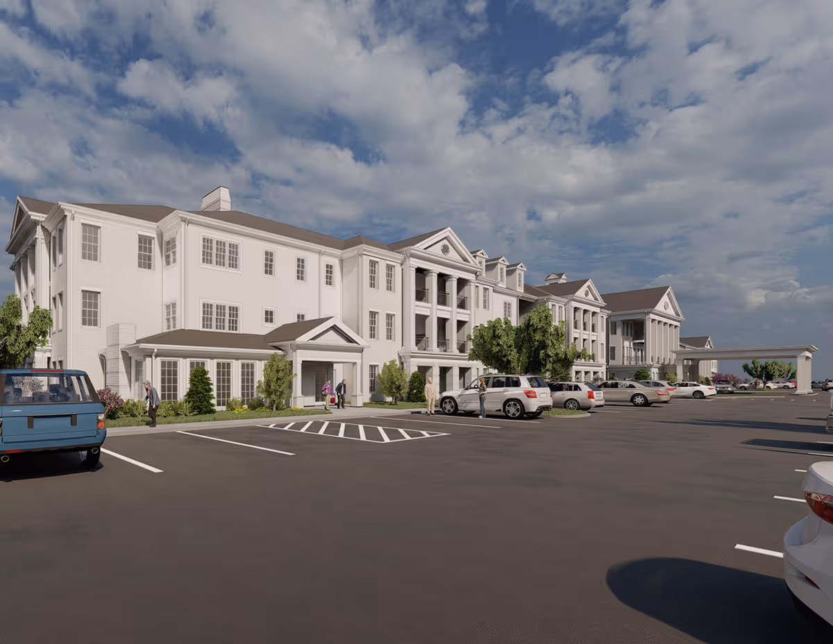 Exterior view of Traditions of Westfield senior living facility with cars in the parking lot.