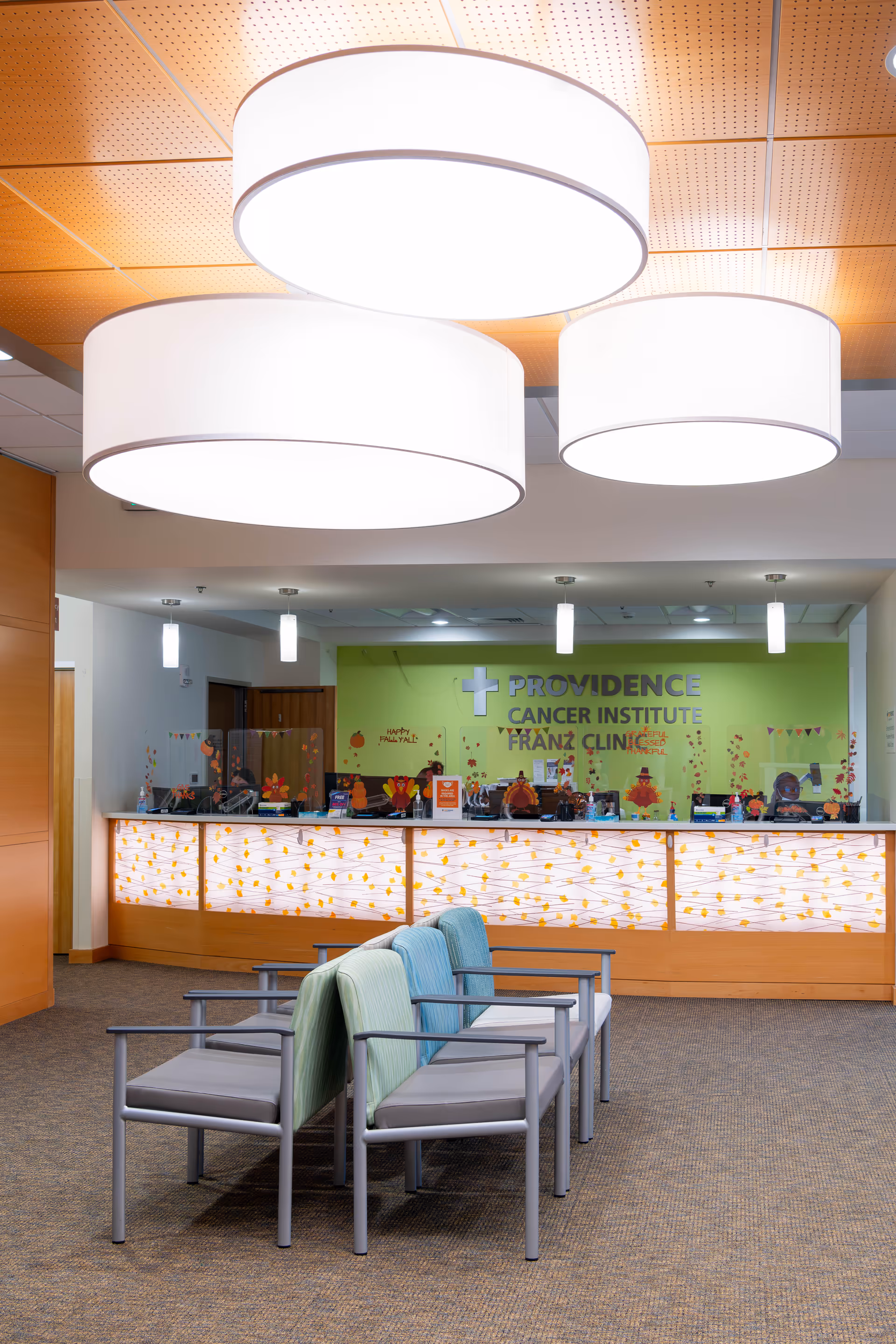 Bright Providence Cancer Institute Franz Clinic reception area with lime wall and seating.