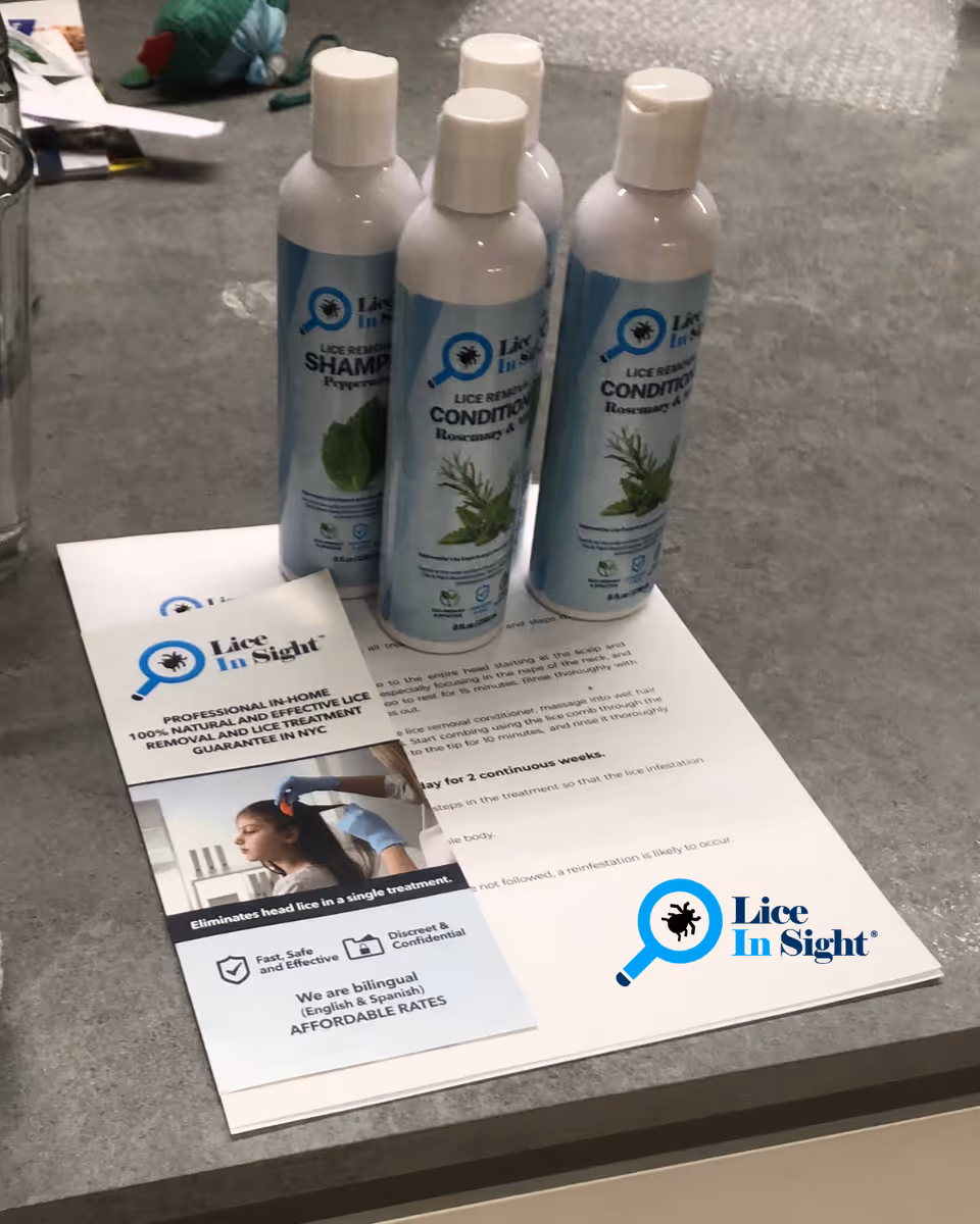 Four white Lice In Sight bottles on a counter with brochures.