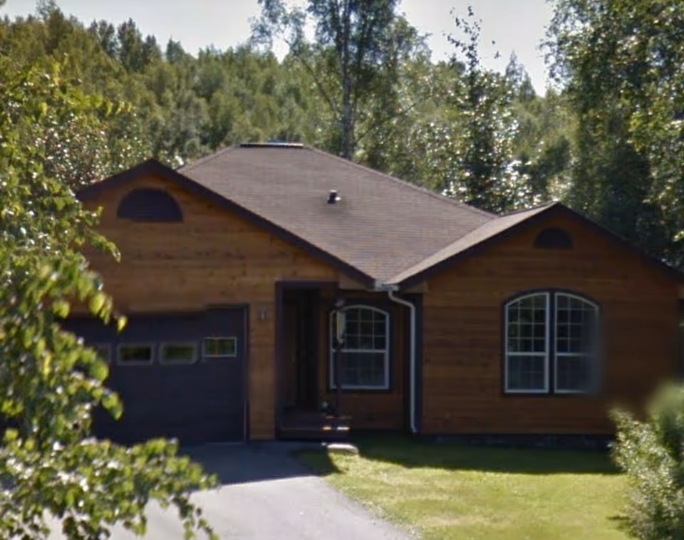 Everly House facility exterior, wooden home with a gabled roof and large arched windows.
