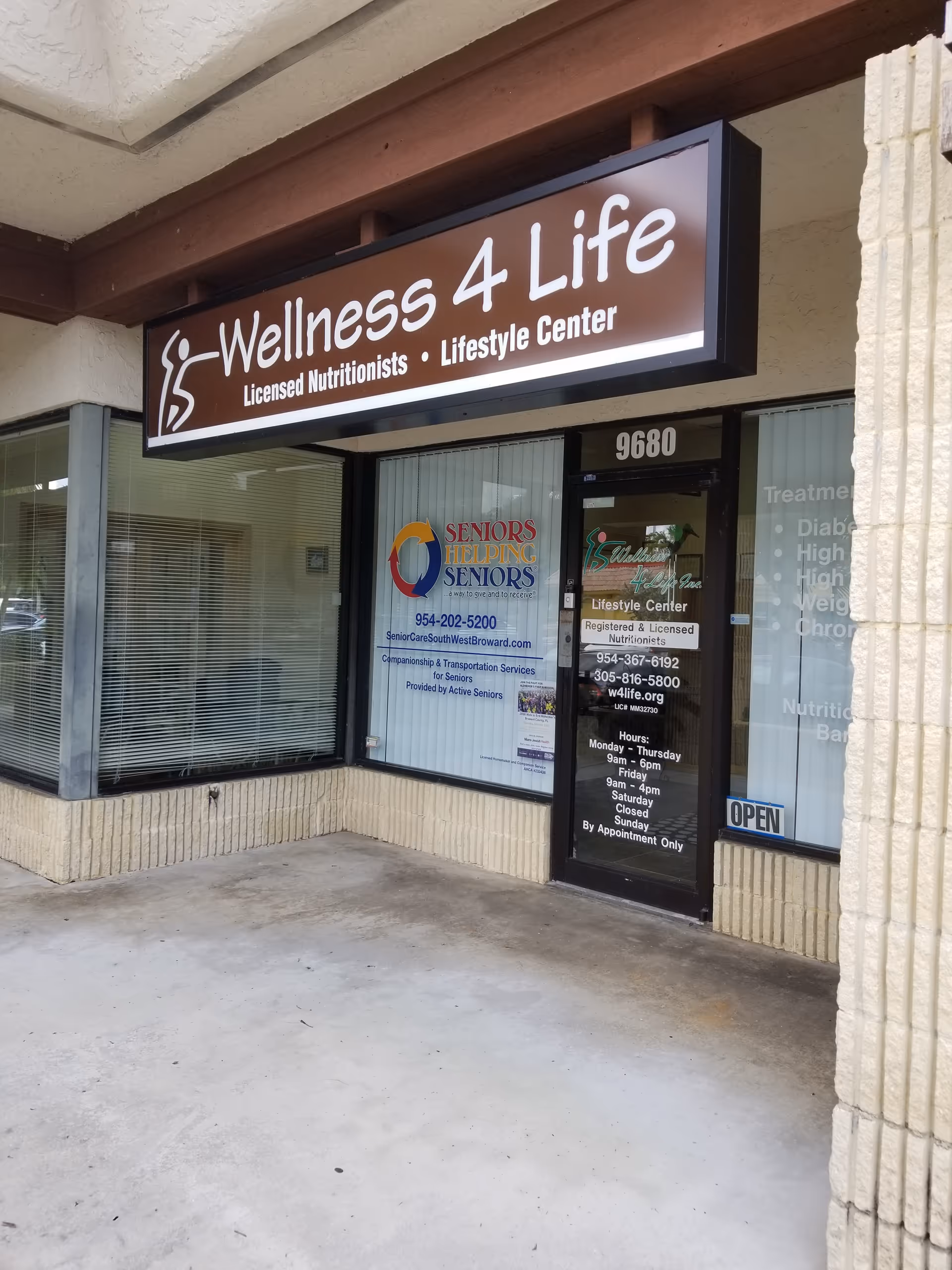 Exterior storefront with a Wellness 4 Life sign and entrance doors for seniors services.