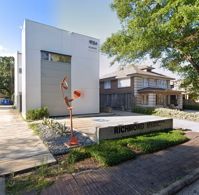 Modern white building with a red sculpture and Richmond Medical sign at the front