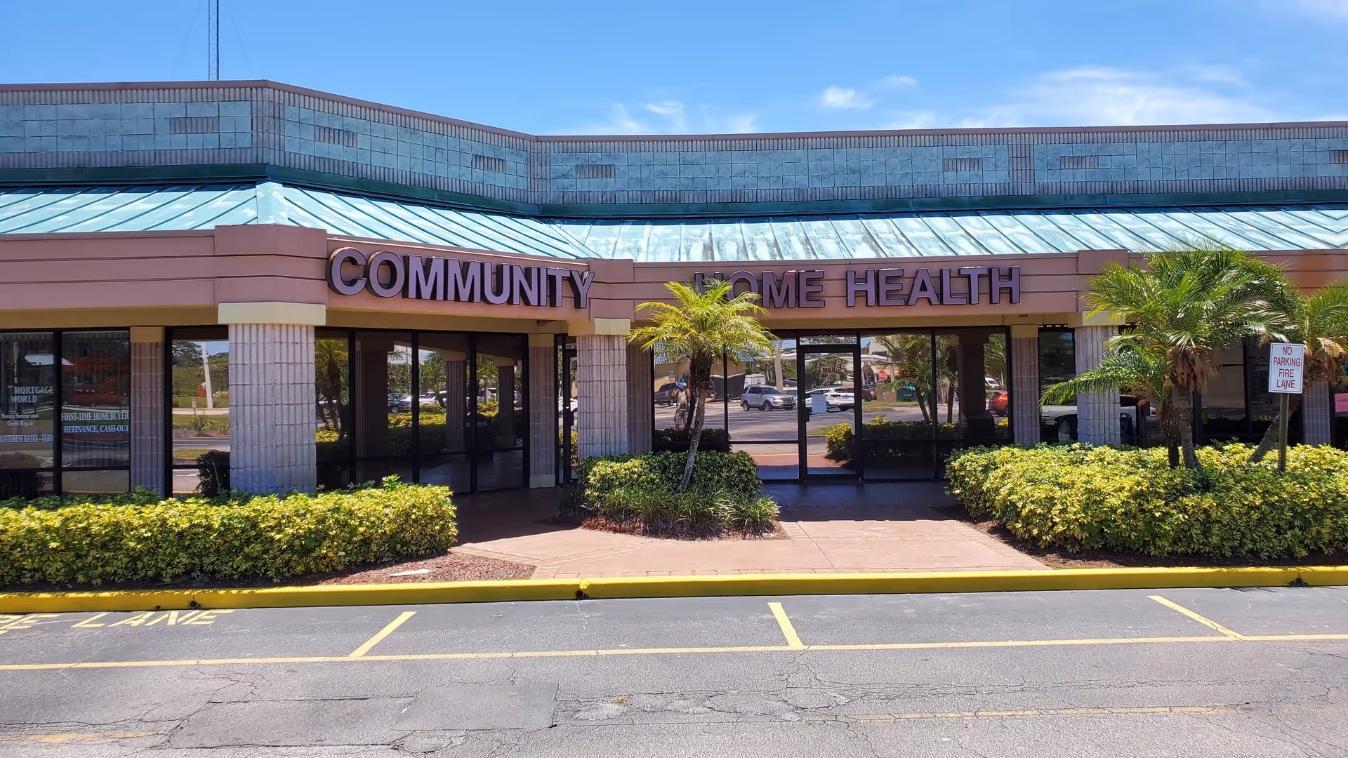 Front view of a single-story building with a 'Community Home Health' sign and landscaped entrance.