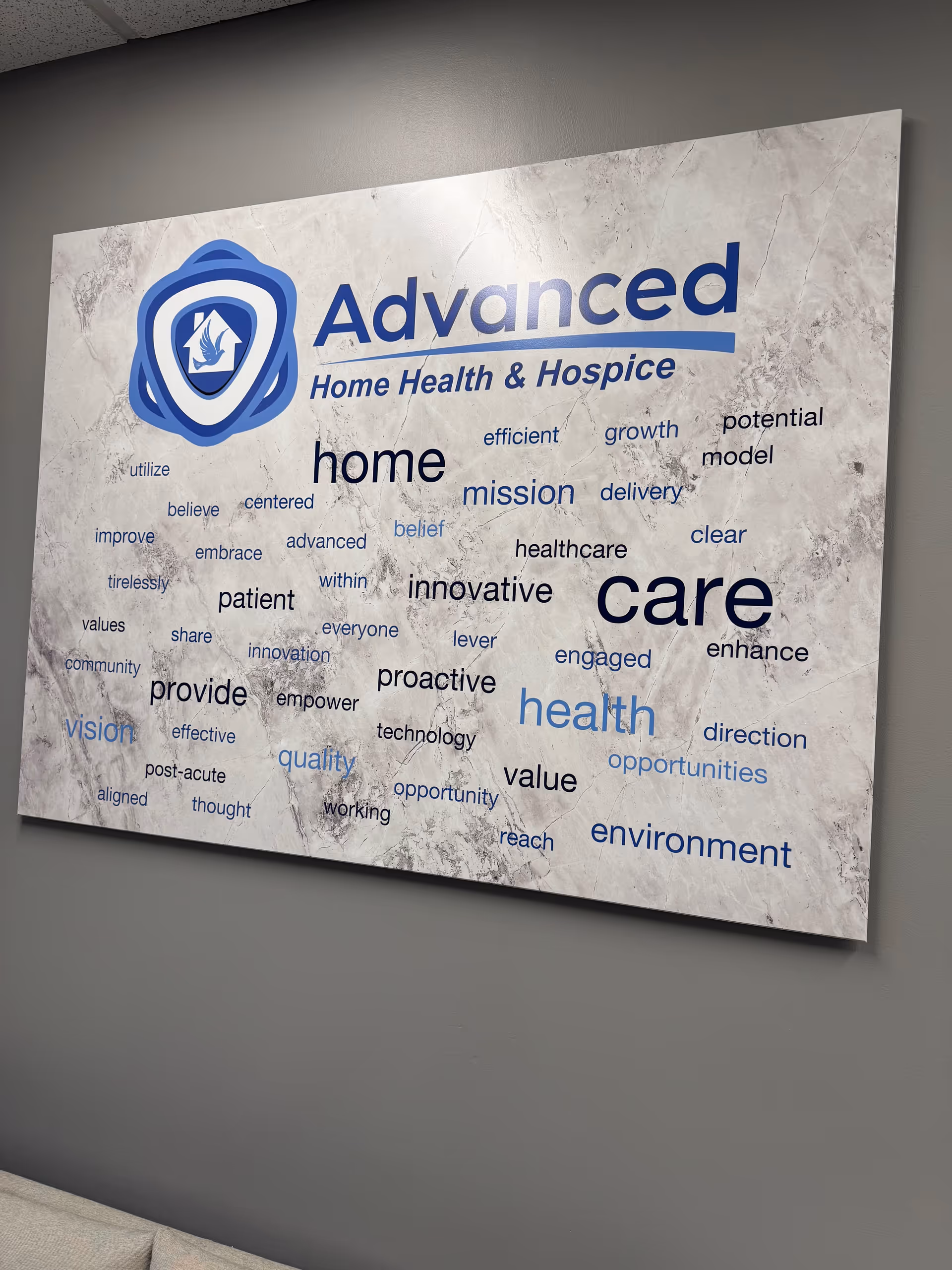 Large wall sign reading 'Advanced Home Health & Hospice' with blue logo and word cloud.