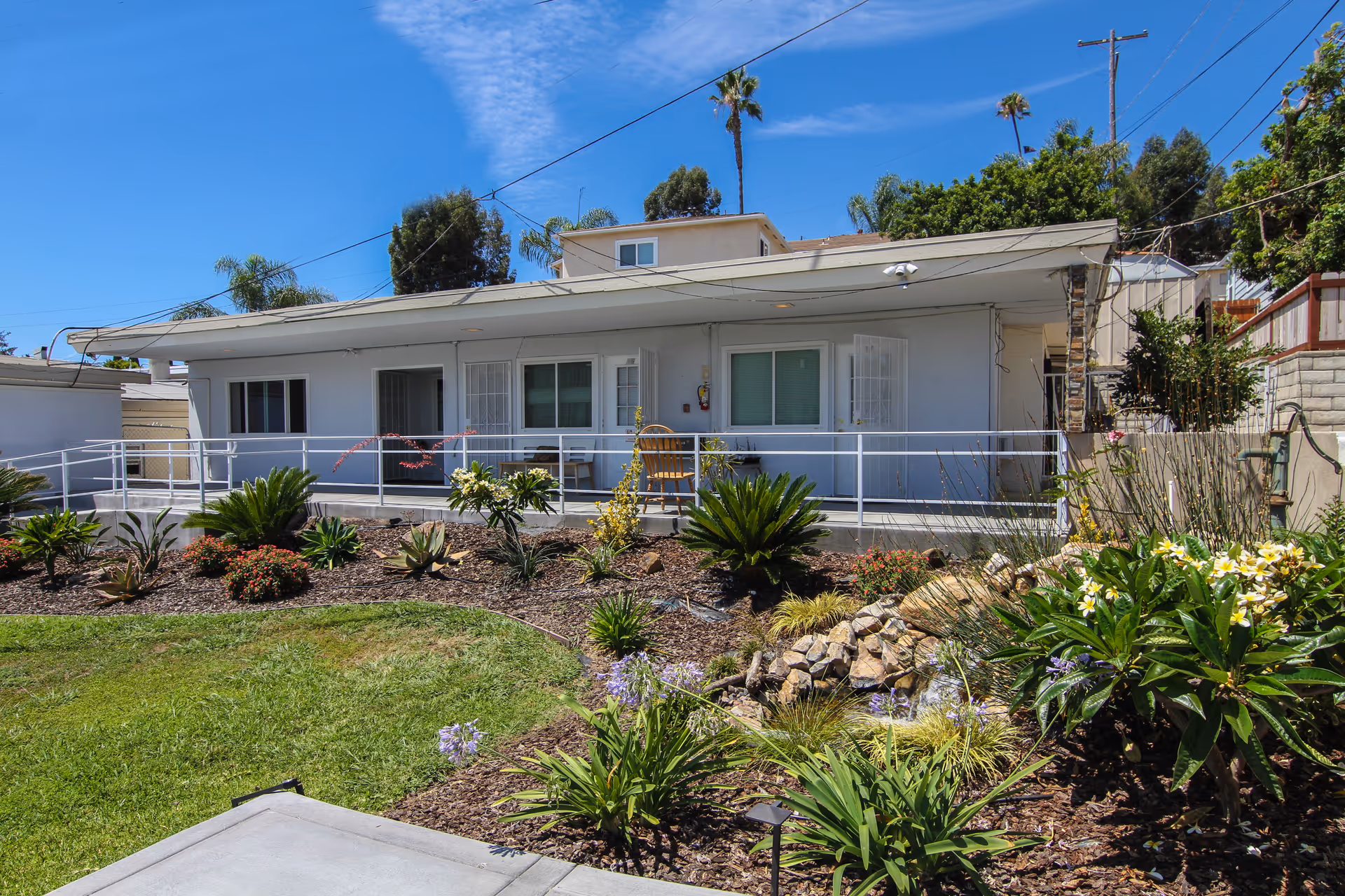 Single-story senior living facility with a ramp and landscaped front yard.