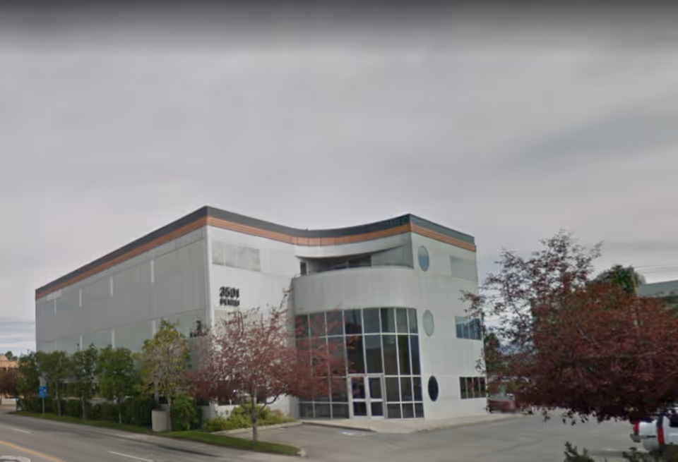 Exterior of Ancora Home Health and Hospice building with curved glass entrance in Anchorage.