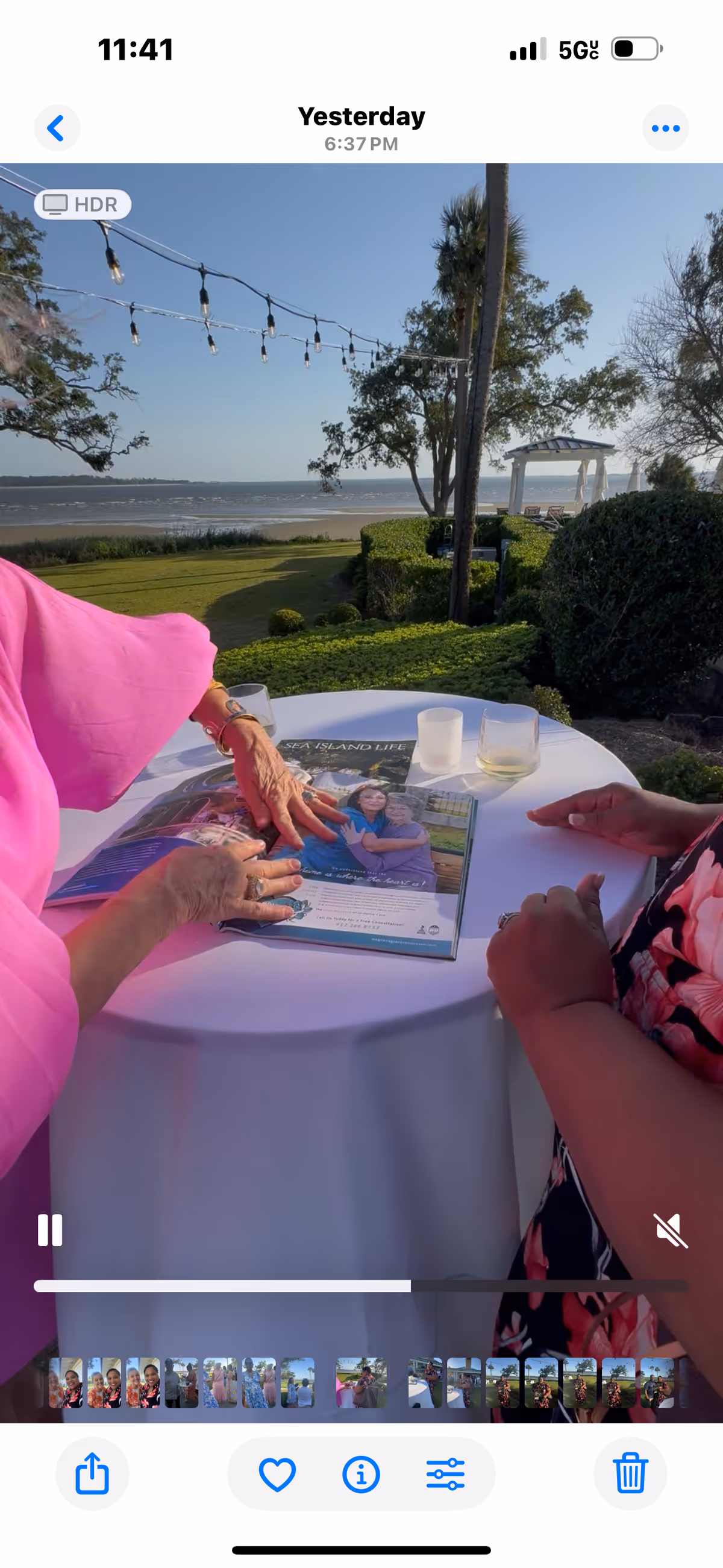 Outdoor patio at Magnolia Grace Senior Care with string lights, table, and magazine.