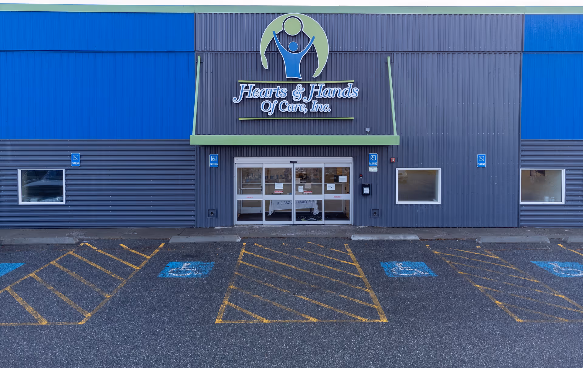 Exterior of Hearts and Hands of Care, Inc. building with a parking lot in front.