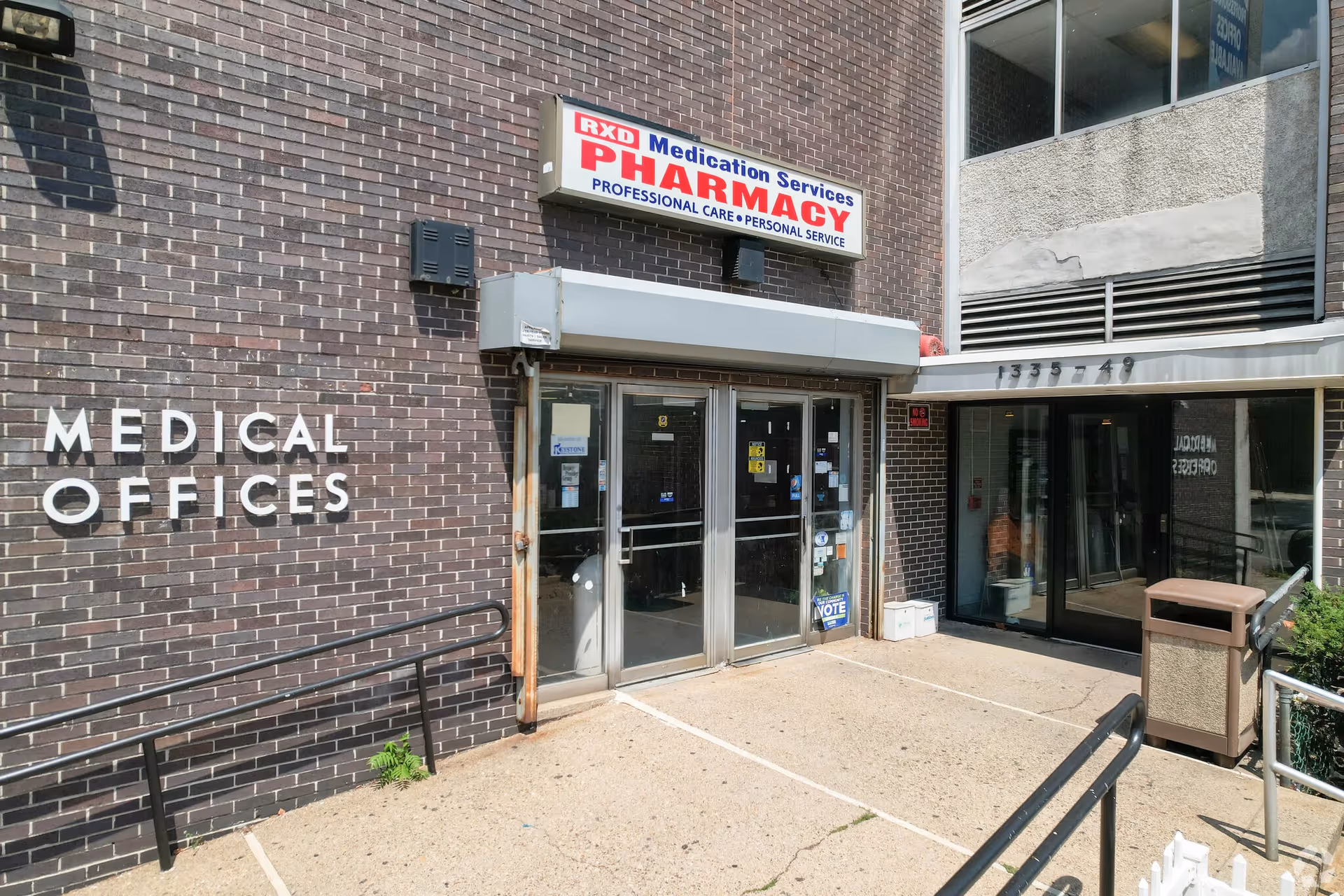 Brick building exterior featuring a Medical Offices sign and a pharmacy entrance.