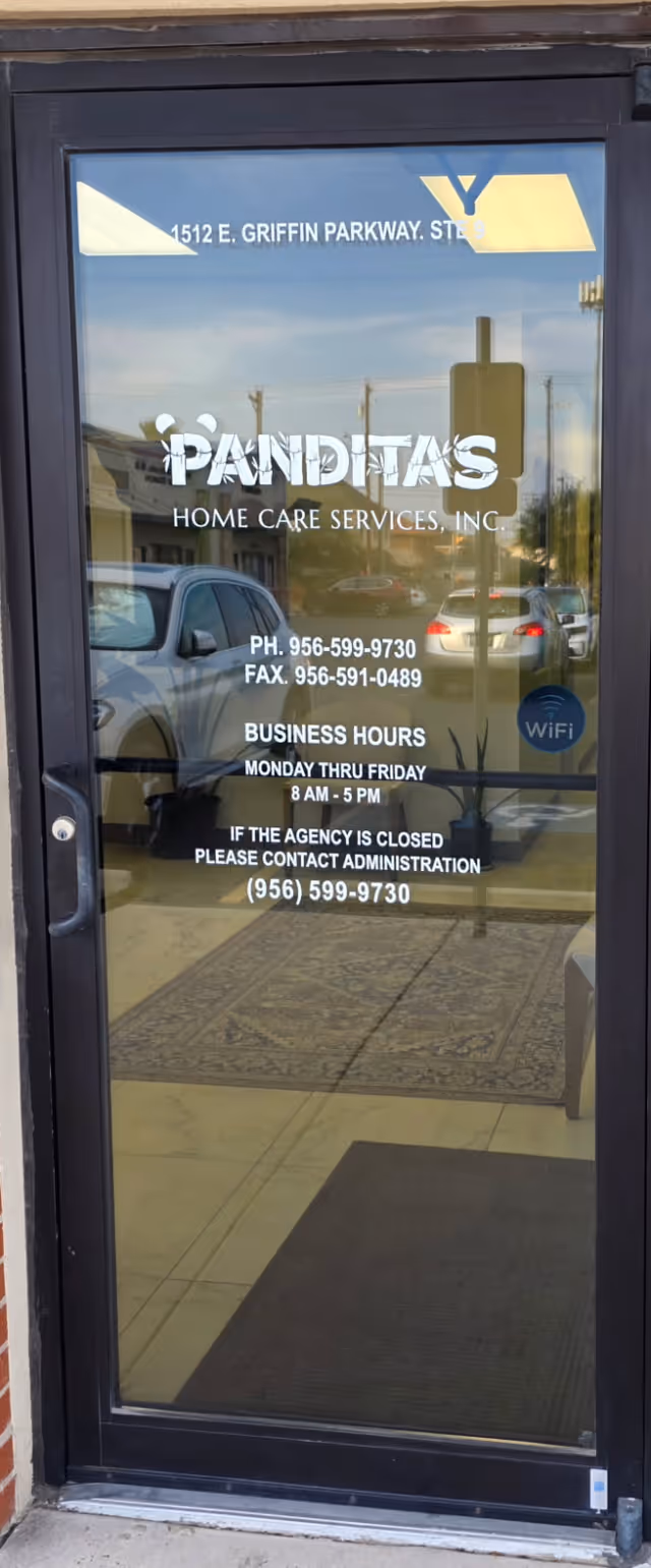 Glass entrance door with Panditas Home Care Services sign and hours.