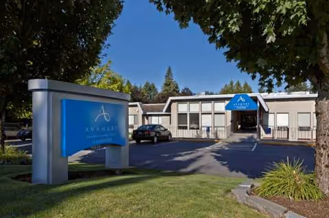 Exterior of Avamere Transitional Care at Sunnyside building with blue sign and parking