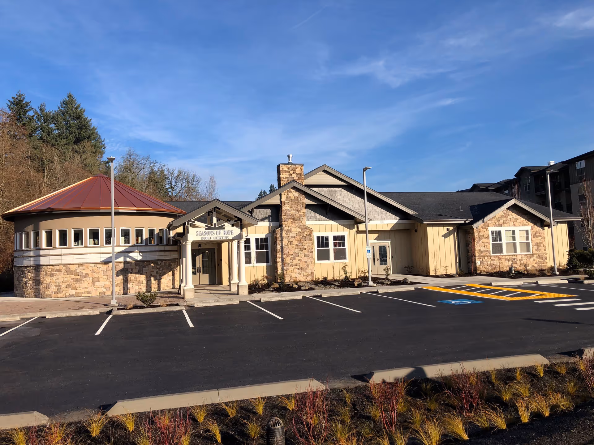 Exterior view of a single-story health care facility with parking and landscaping.