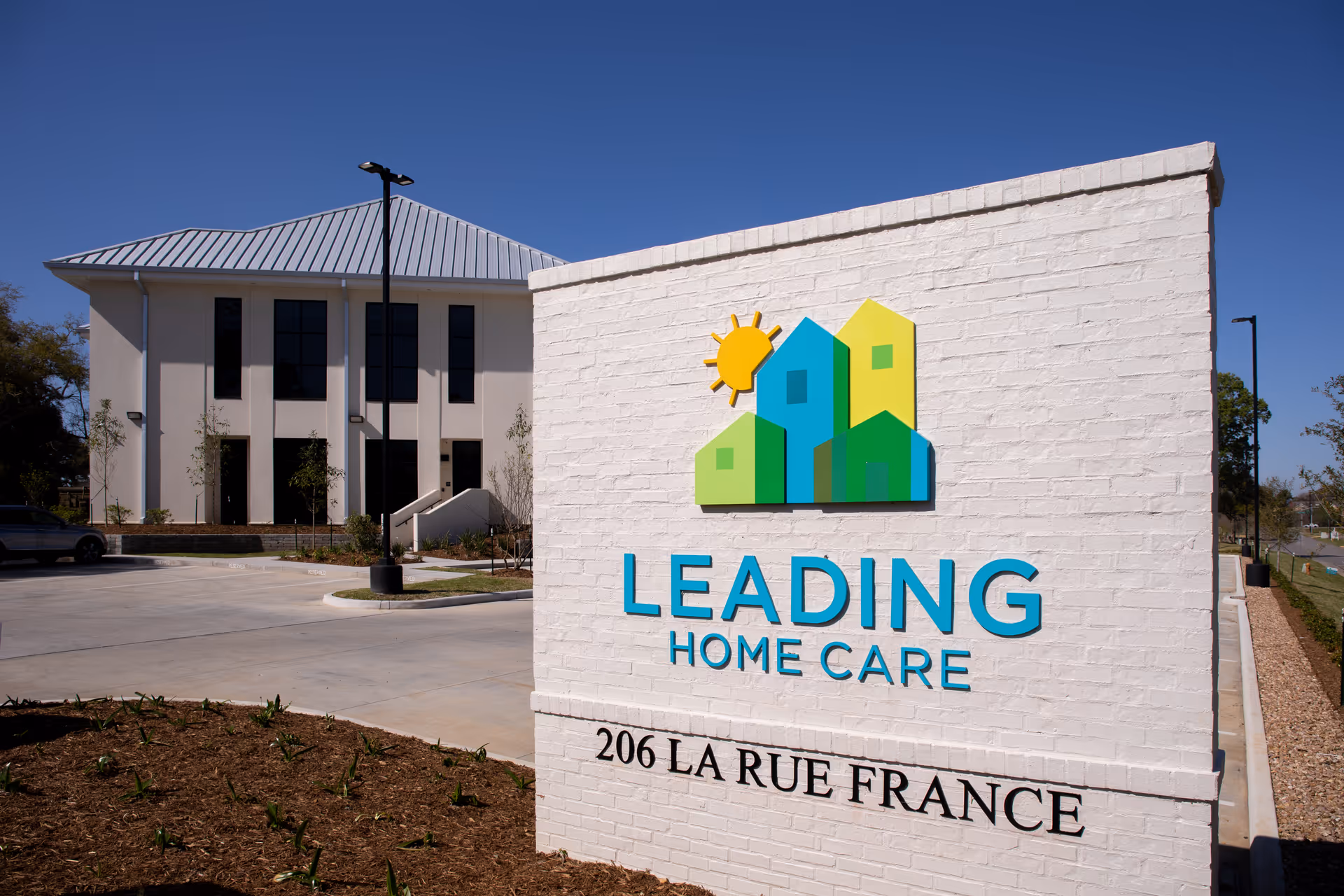 Exterior view of Leading Home Care Lafayette sign on a modern building.