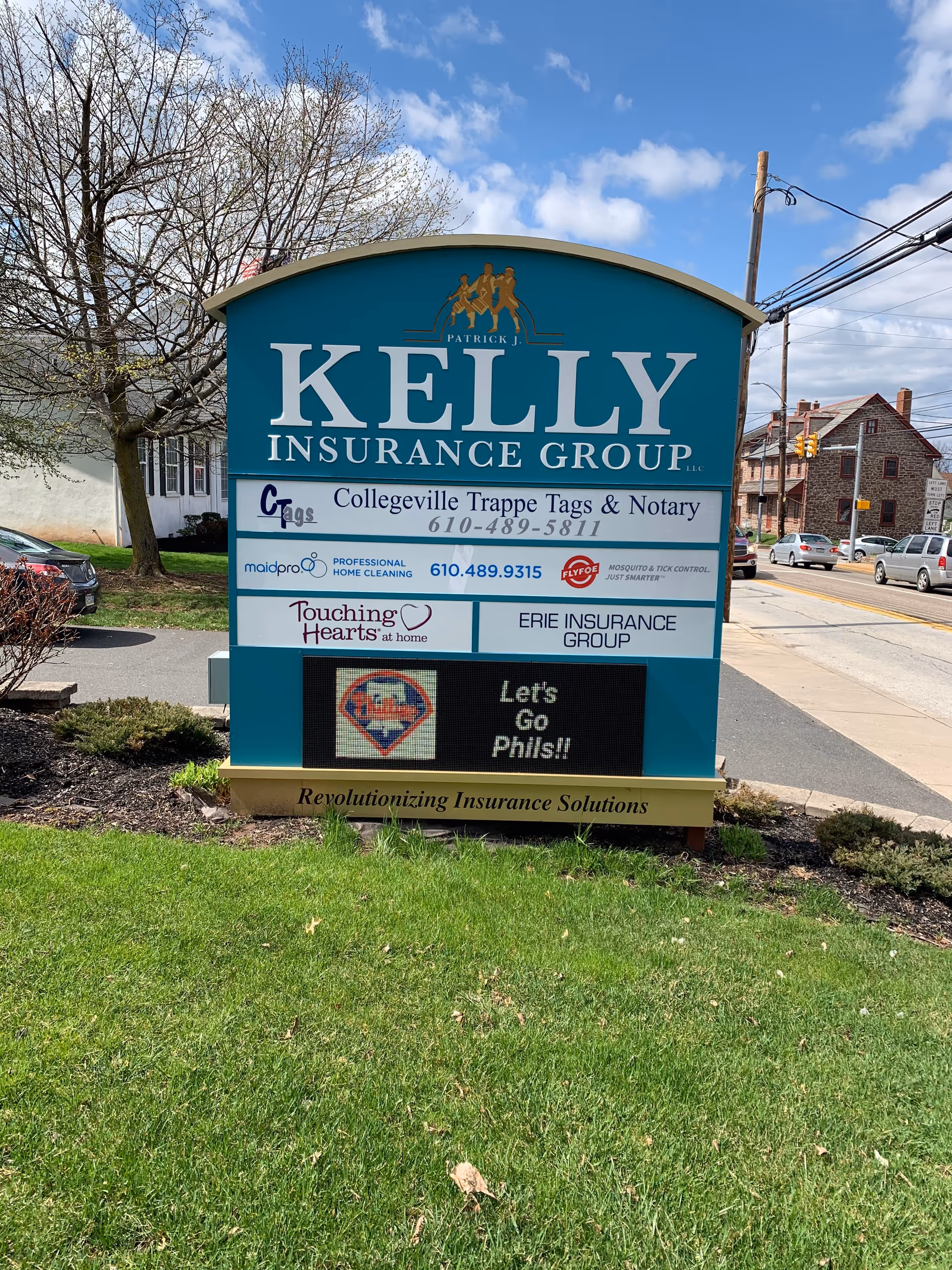 Large outdoor sign for Touching Hearts at Home Montco PA with insurance group logos.