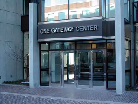 Exterior glass-front entrance labeled One Gateway Center with automatic doors.