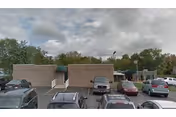 Front view of Haven Convalescent Home with parked cars in the lot.