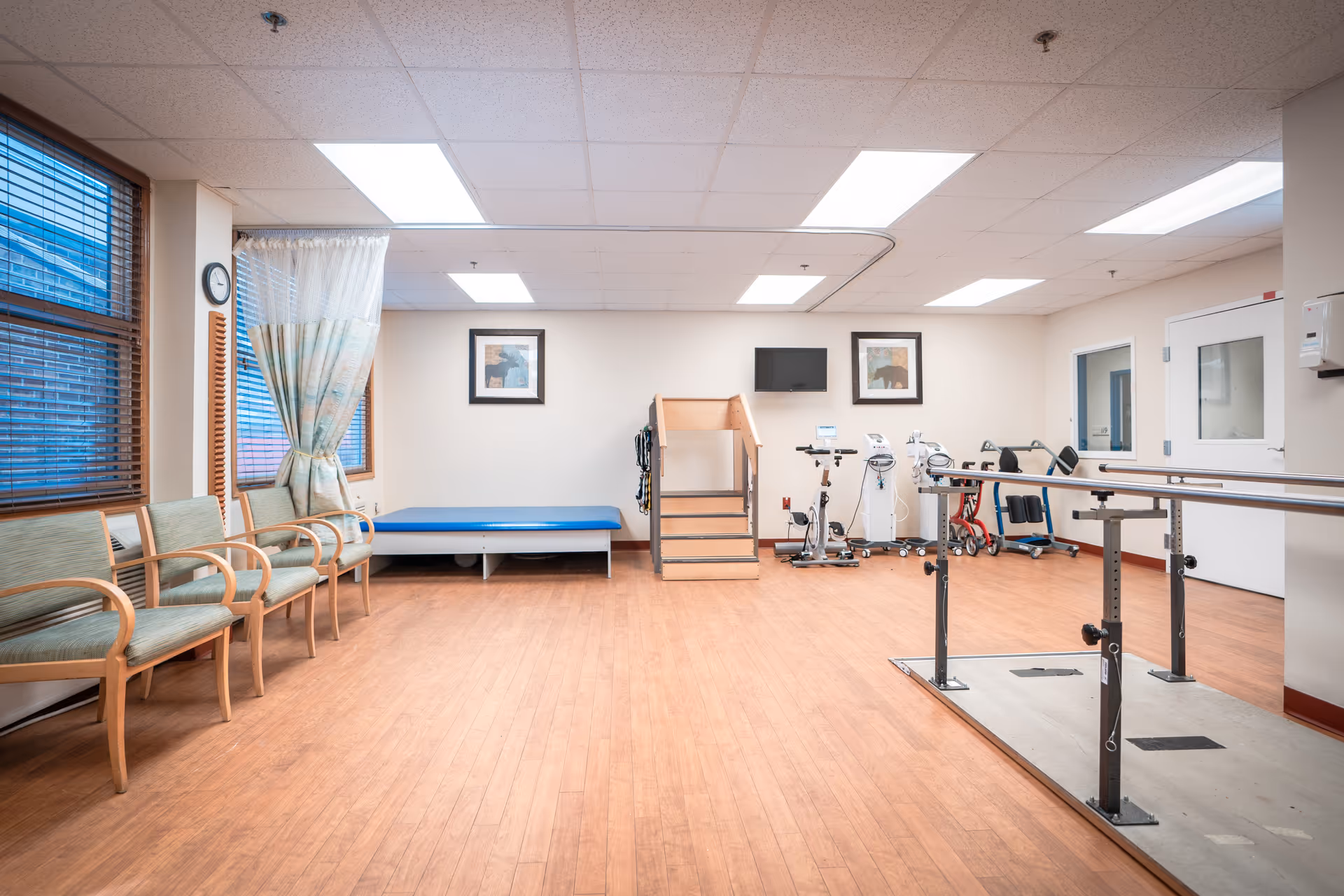 Interior rehabilitation gym at Gardens at Millville with exercise equipment and seating