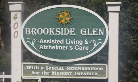 Outdoor sign at the facility entrance reading Brookside Glen Assisted Living & Alzheimer's Care.