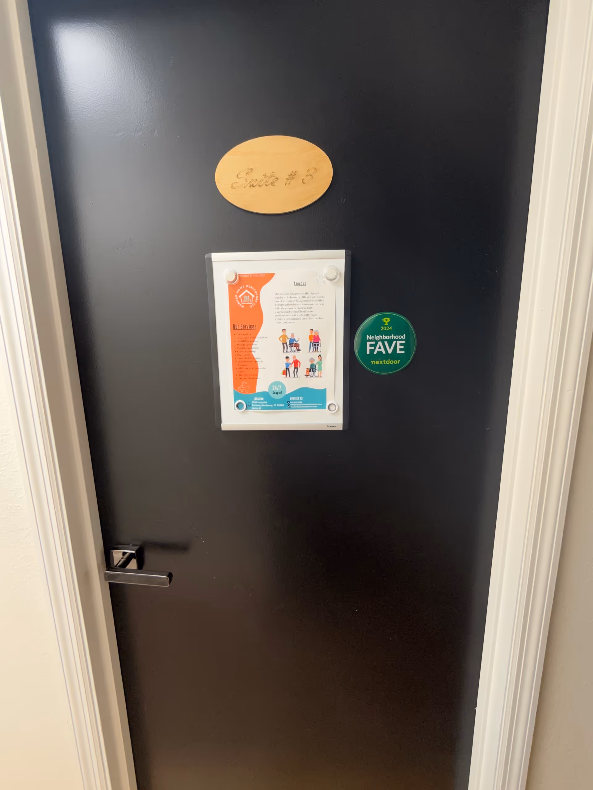 A dark interior door with a wooden Suite #3 plaque and brochure display.