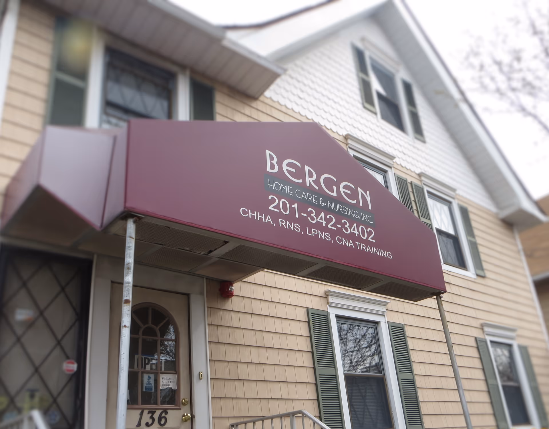 Exterior view of a two-story building with a maroon sign reading BERGEN HOME CARE NURSING