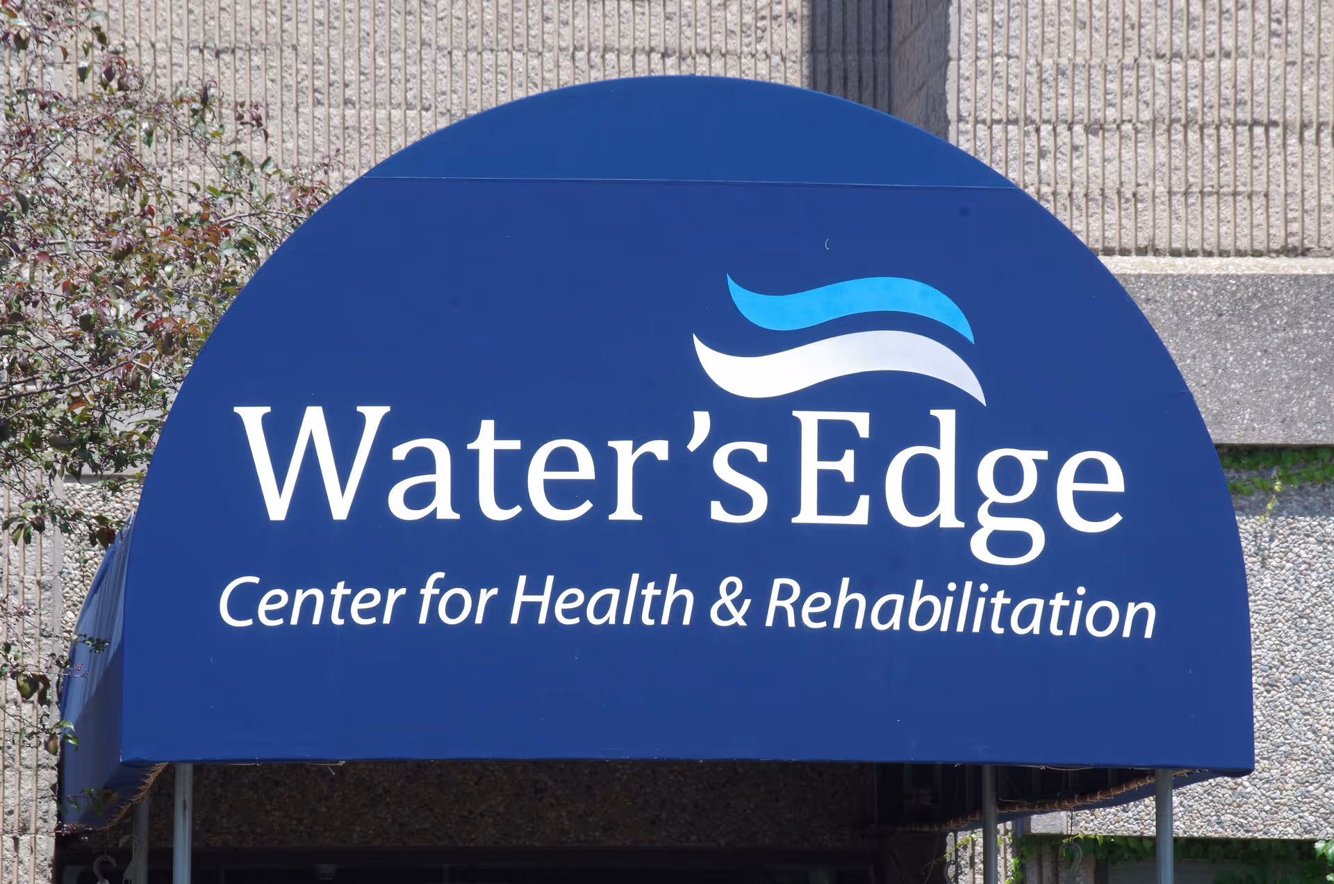 Blue curved awning sign reading Water's Edge Center for Health & Rehabilitation