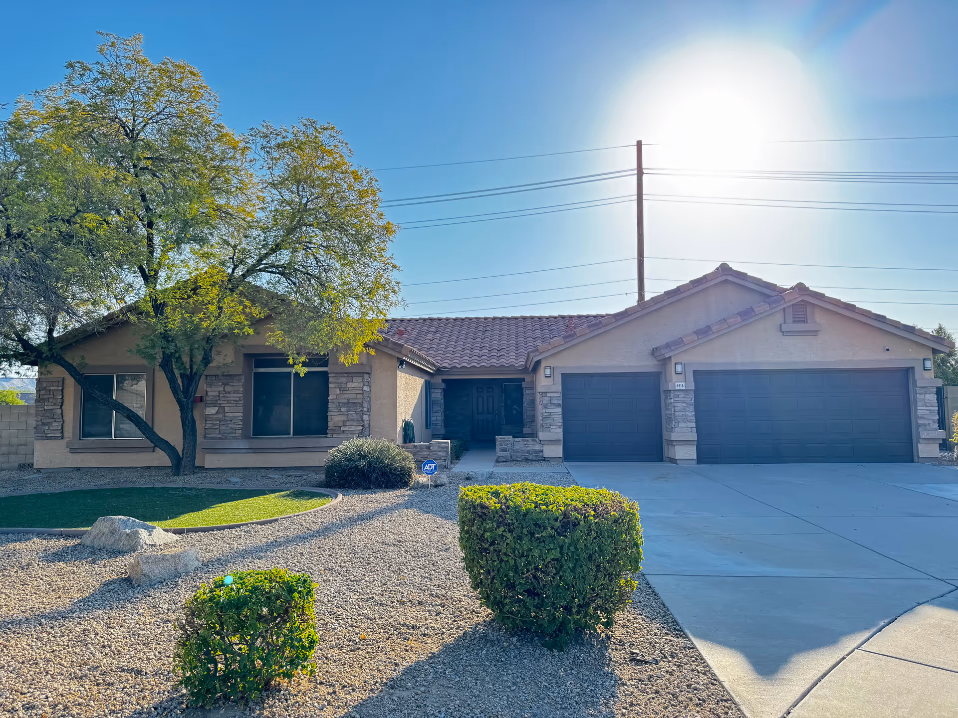 Front exterior of a single-story senior living facility with desert landscaping.