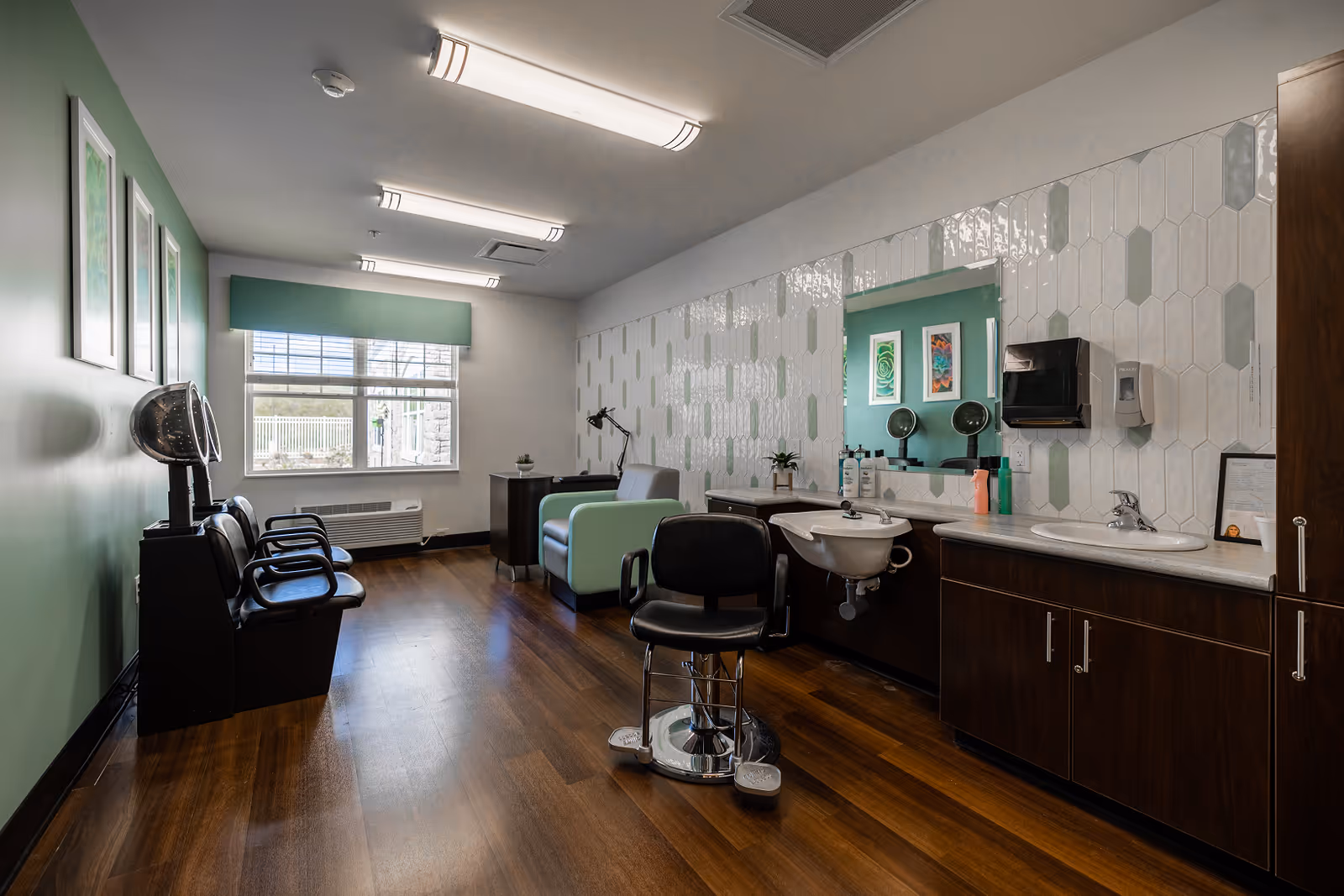 Interior hair salon in Harbor Terrace Senior Living with chairs, sinks, mirrors, and wood flooring.