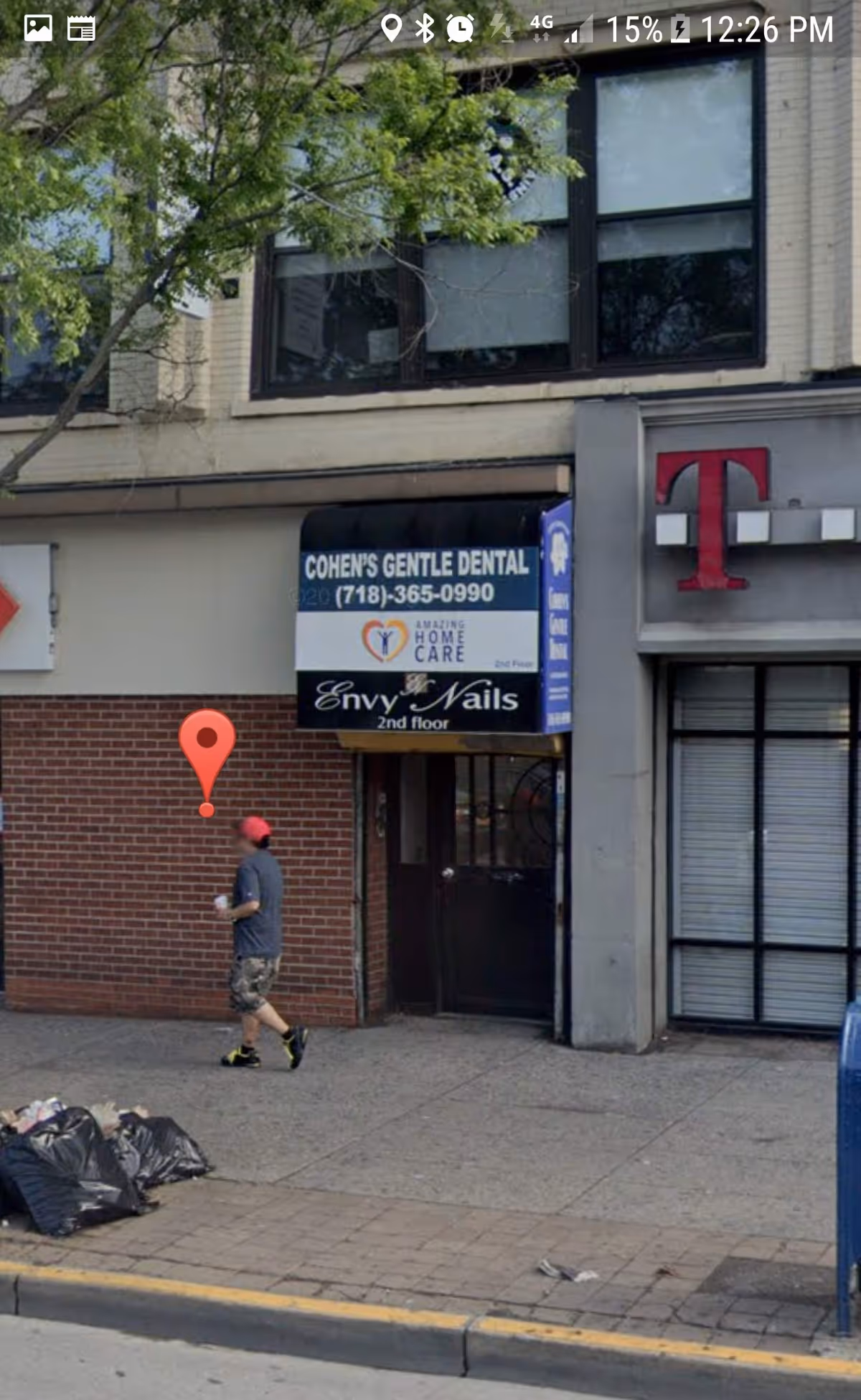 City sidewalk storefronts with Amazing Home Care sign and a dental clinic.