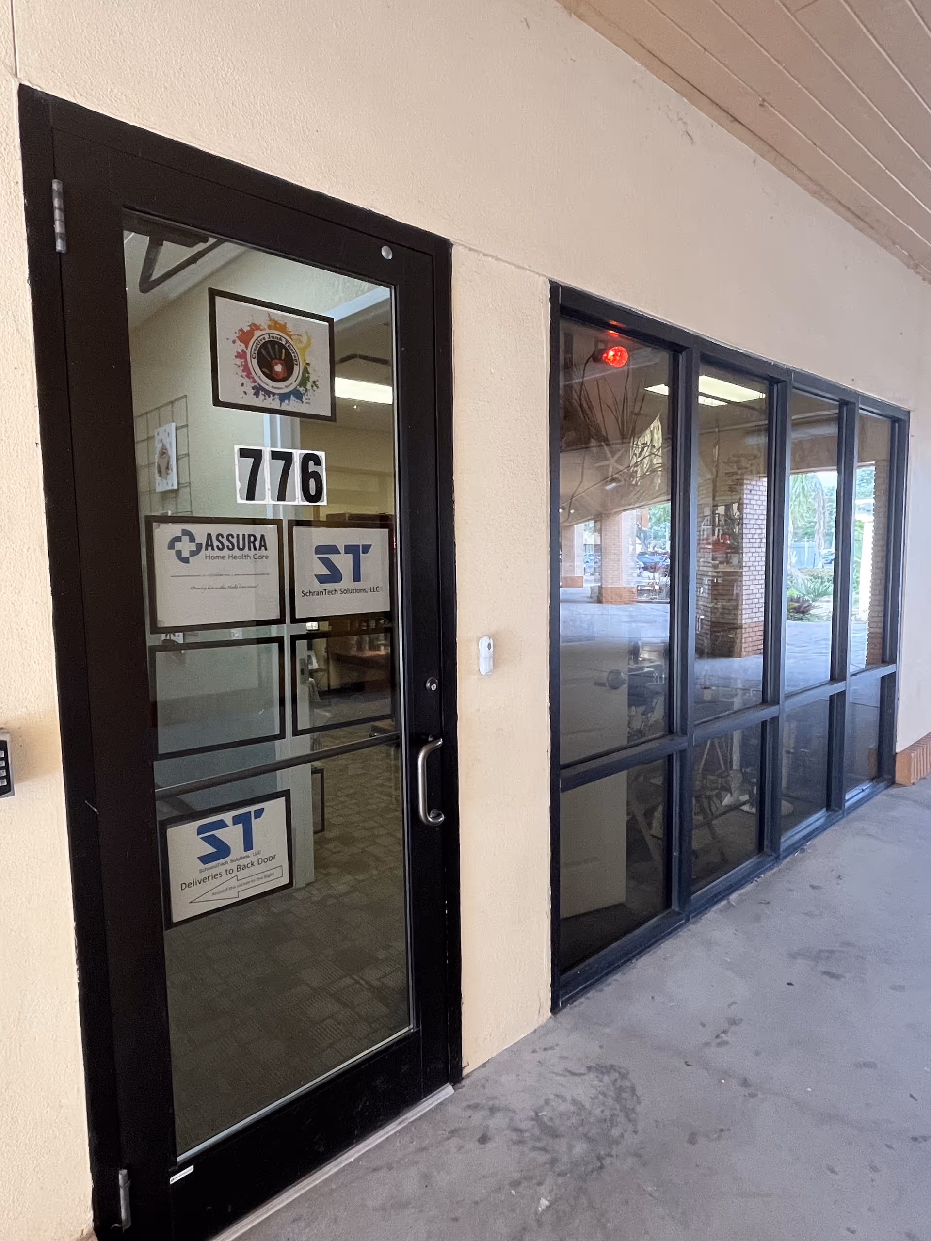 Black-framed glass door and large windows mark the entrance to Assura Home Health Care LLC.