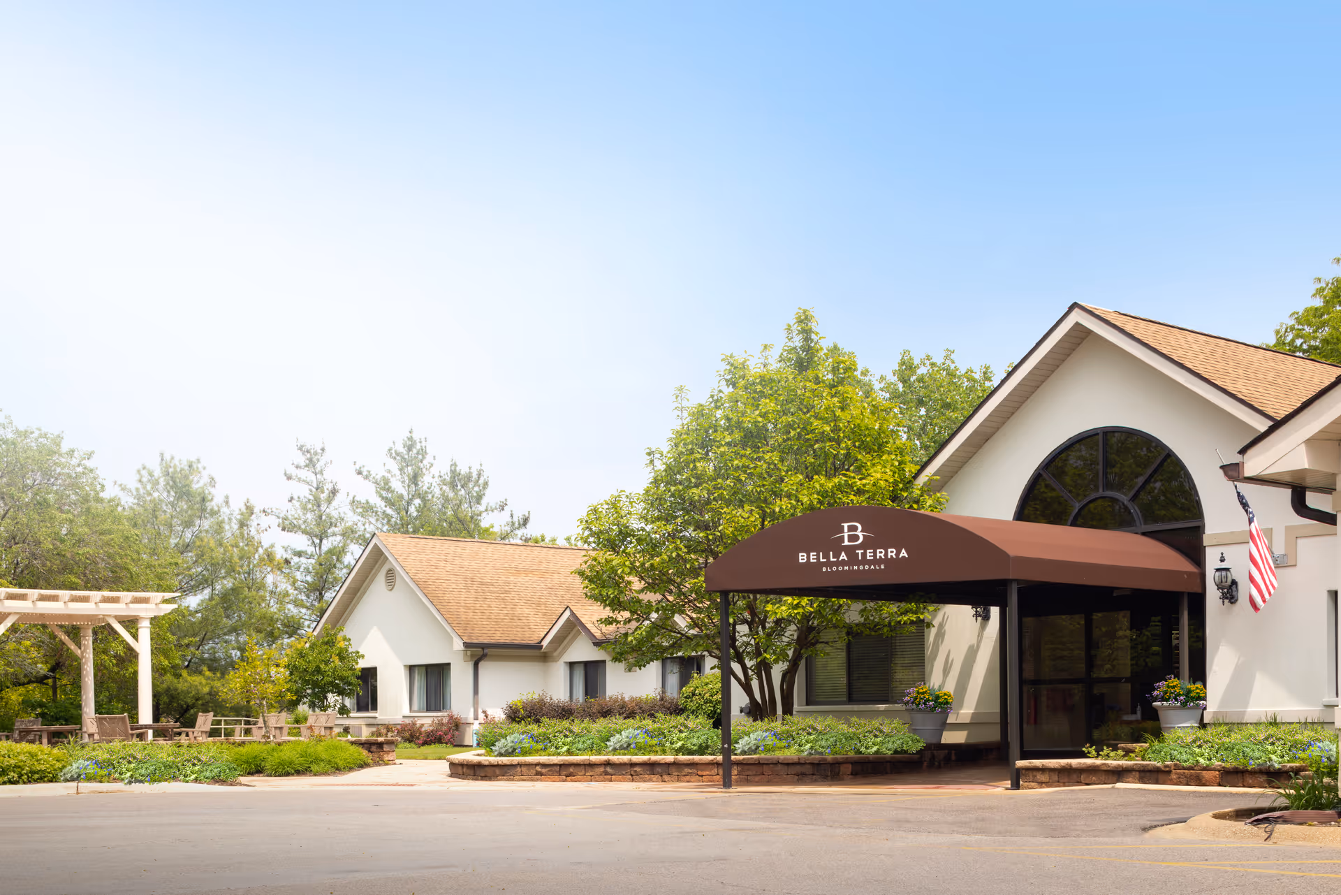 Exterior view of Bella Terra Bloomingdale entrance with brown awning and landscaping.