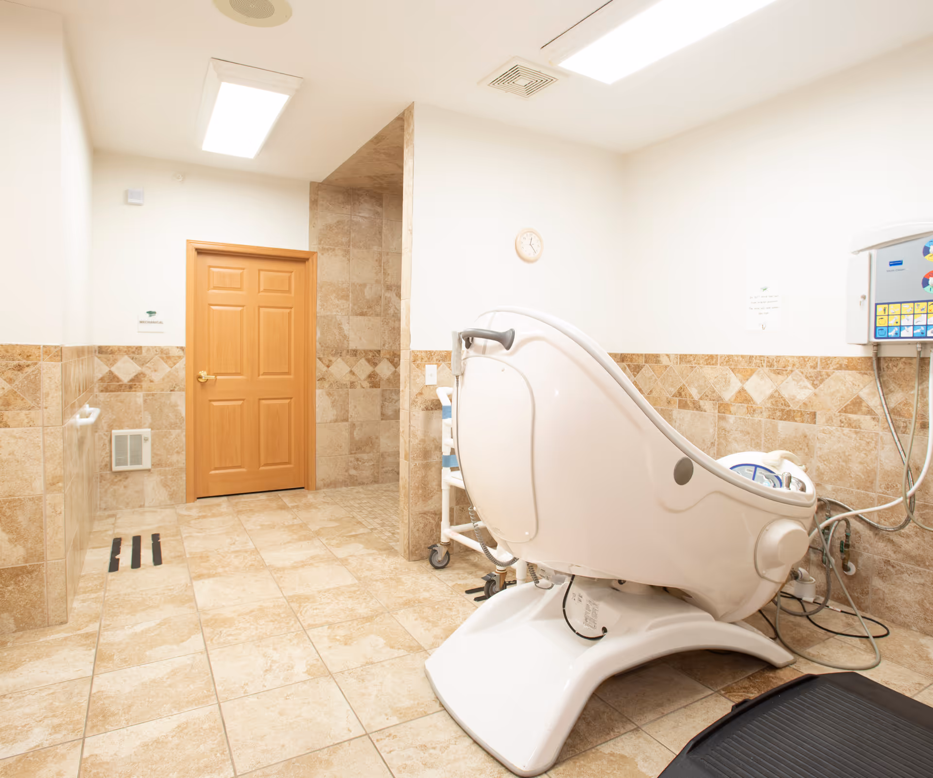Beige tiled Bayside Manor bathroom with a white hydrotherapy tub.