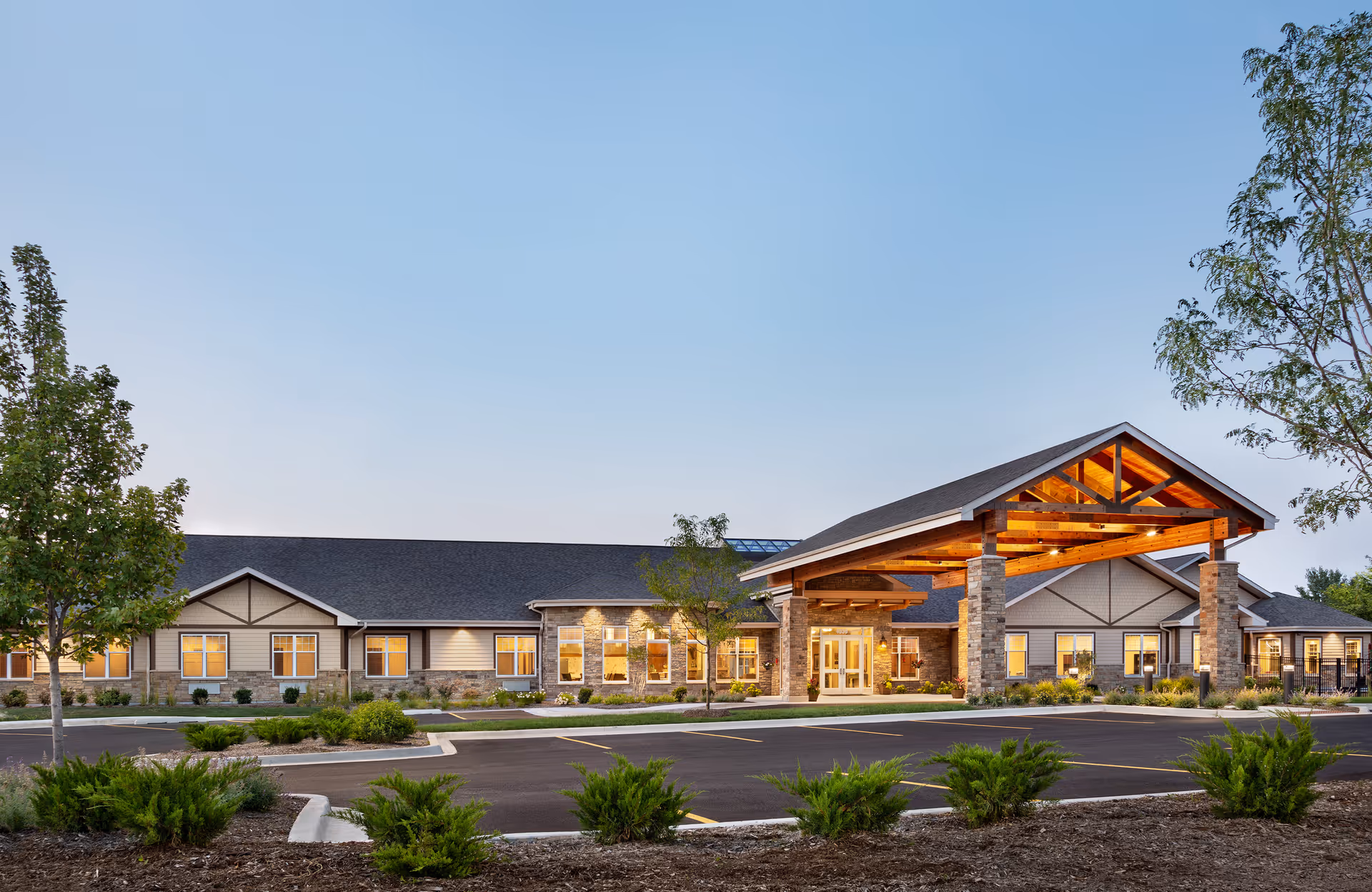 Exterior view of Silverado St. Charles Memory Care Community with a covered entrance and parking.