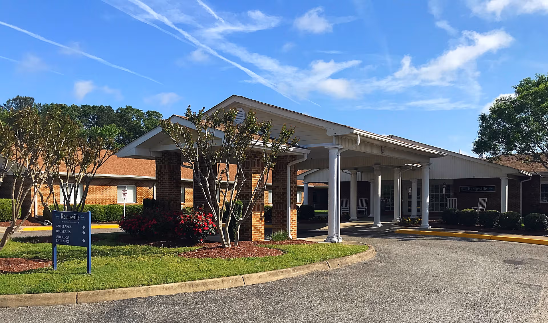 Exterior view of Kempsville Health and Rehab Center entrance with brick building and porte-cochere