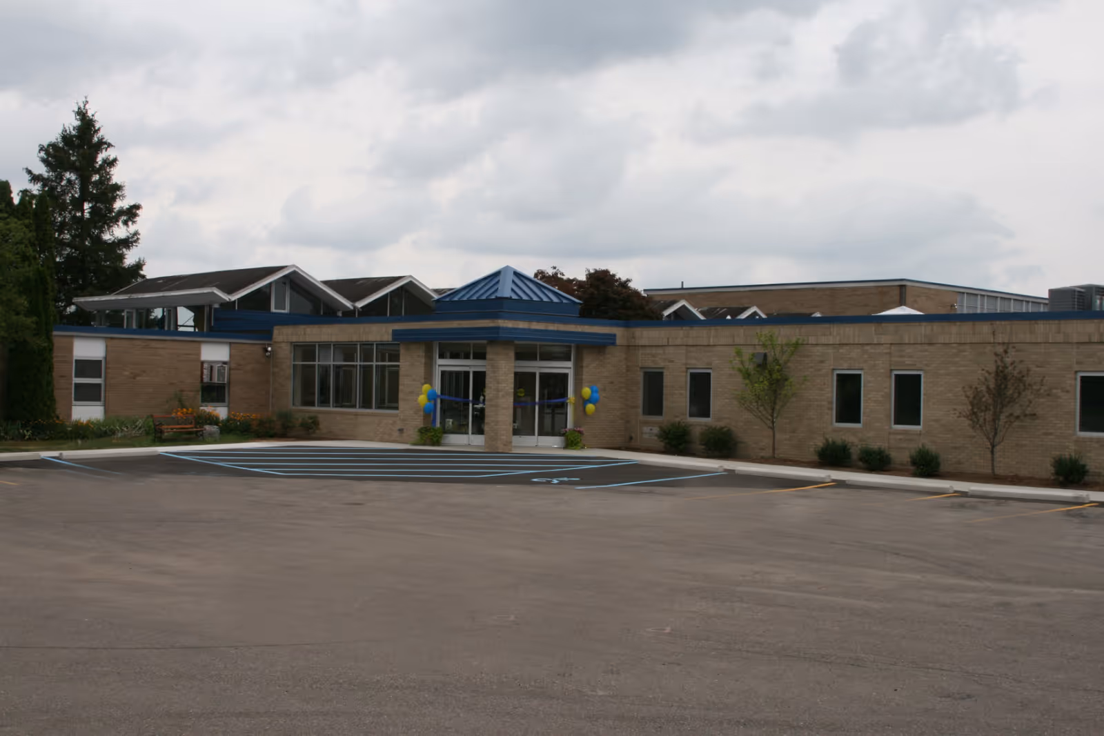 Exterior view of St Louis Center building with entrance and parking lot