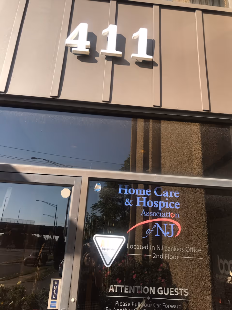 Exterior building entrance with glass doors and Home Care & Hospice Association of New Jersey signage.