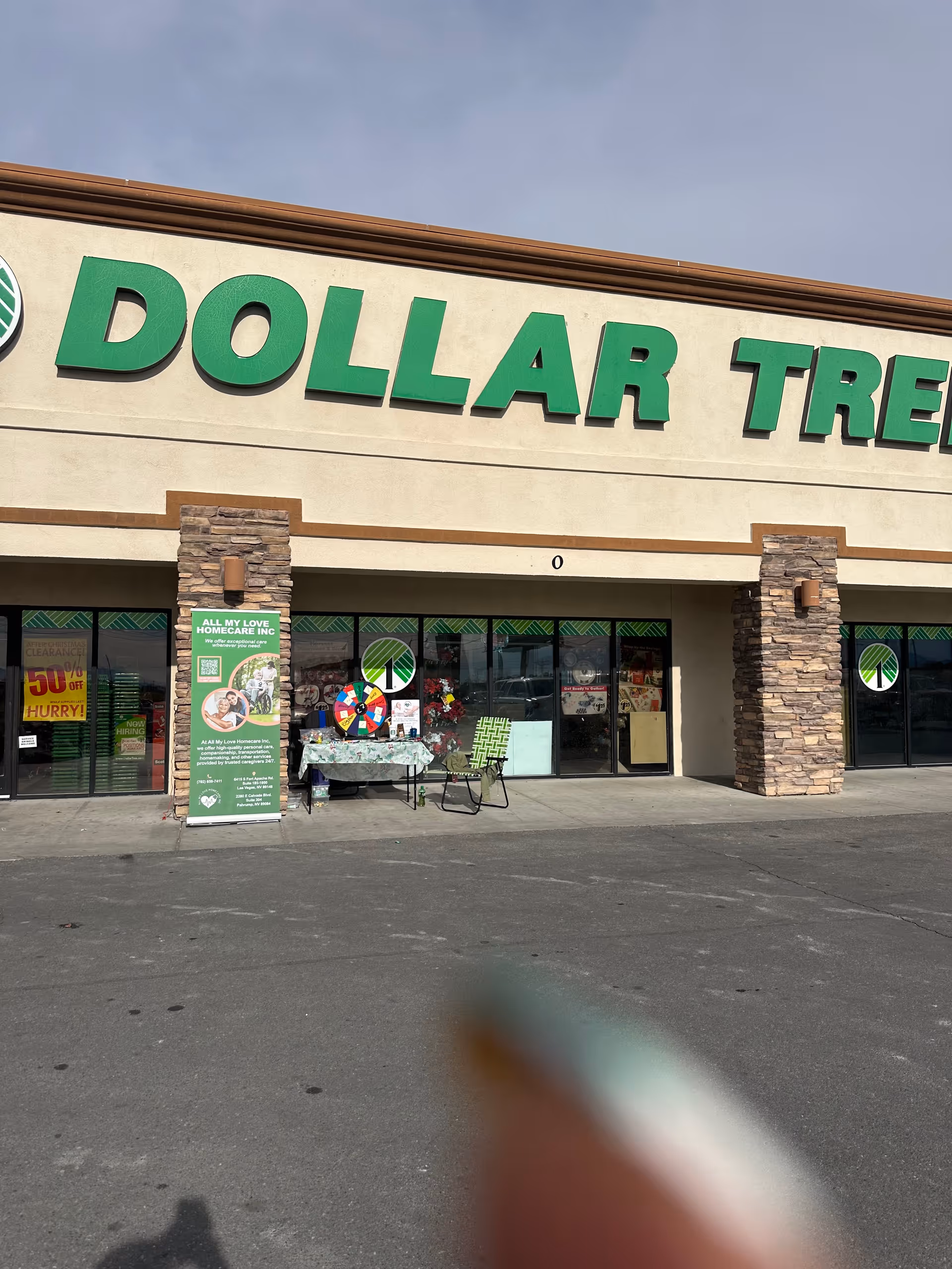 Storefront of a Dollar Tree with a promotional display for All My Love Homecare Inc outside.
