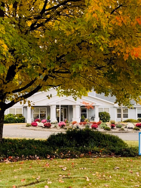 Front view of Applegate Place building entrance with autumn landscaping.
