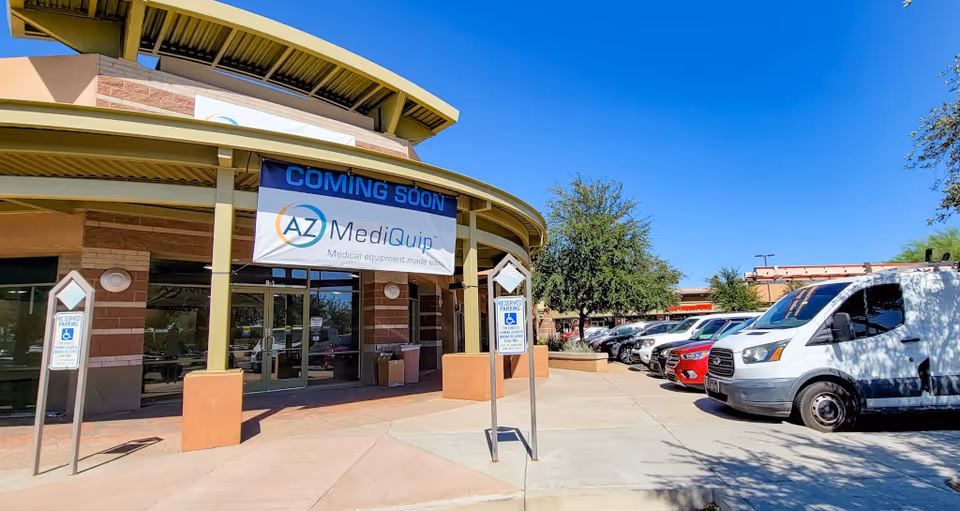 Exterior of AZ MediQuip Goodyear with a Coming Soon banner and parked vehicles.