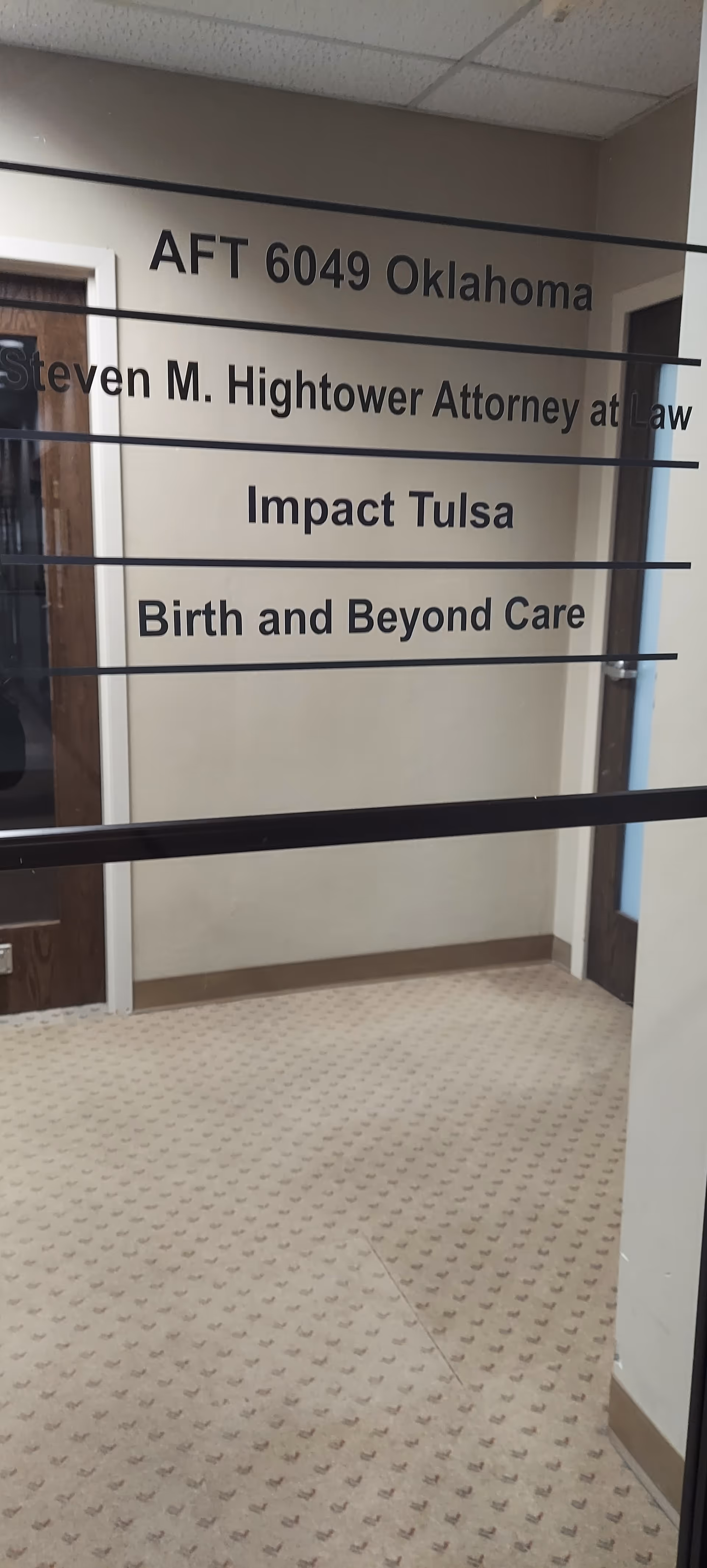 Interior corridor featuring doorway signs, including Birth and Beyond Care sign.