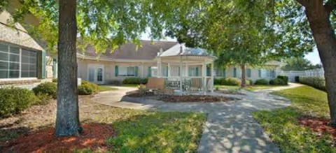 Exterior view of Brookdale Canopy Oaks showing a walkway to a small front porch