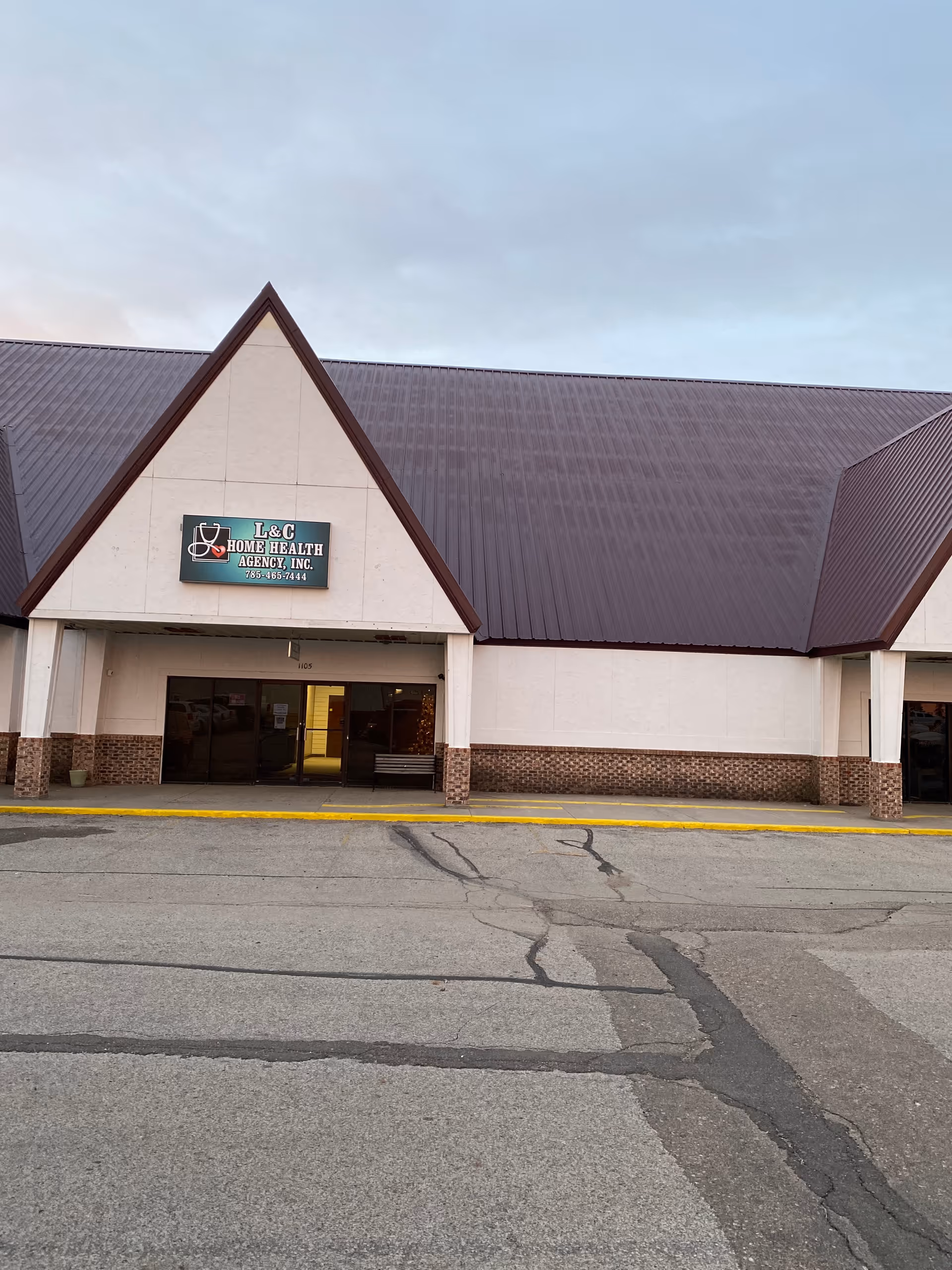 Front exterior of L&C Home Health Agency building with sign and open entrance.