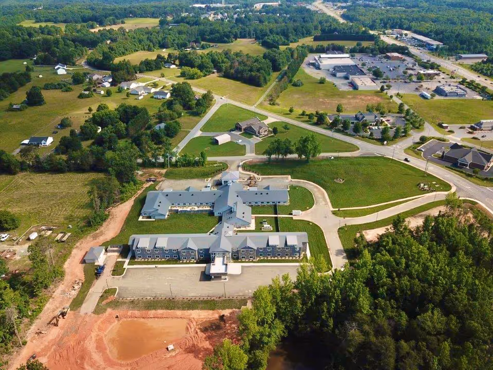Aerial view of The Landings of Rockingham campus with winding driveways and green fields.