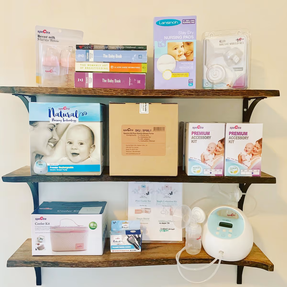 Three wooden shelves display breastfeeding products and infant care boxes.