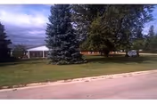 Exterior view of Riceville Family Care and Therapy Center with trees and lawn.
