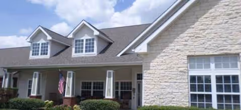 Exterior view of Brookdale Western Hills facility with porch, windows, and landscaping.