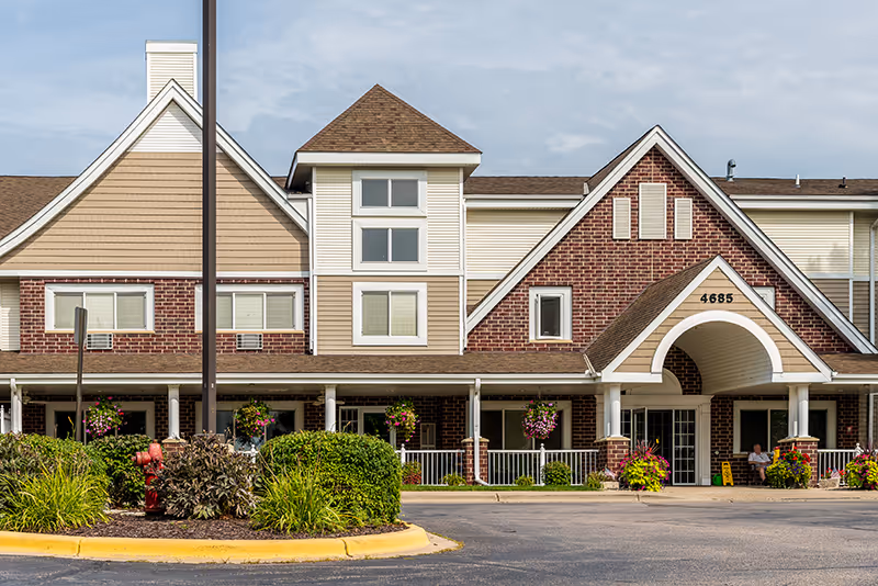 Front exterior view of New Perspective Senior Living, Prior Lake, with brick archway entrance.