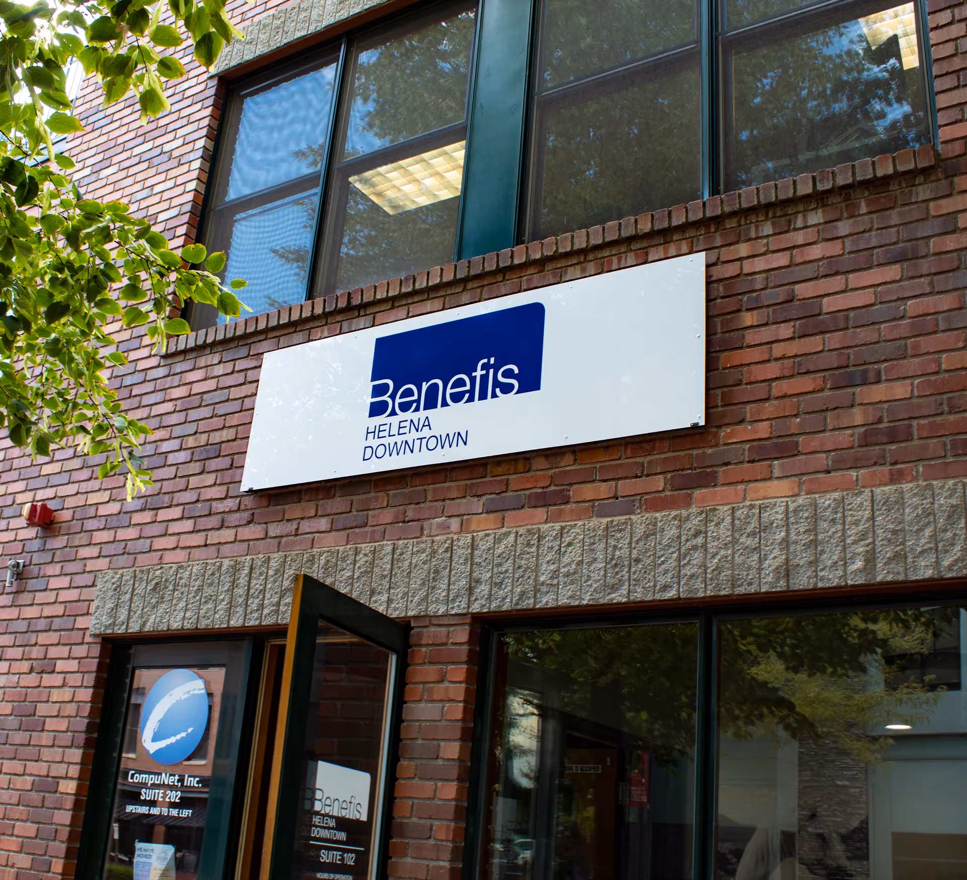Brick building exterior with a Benefis sign and large front windows.