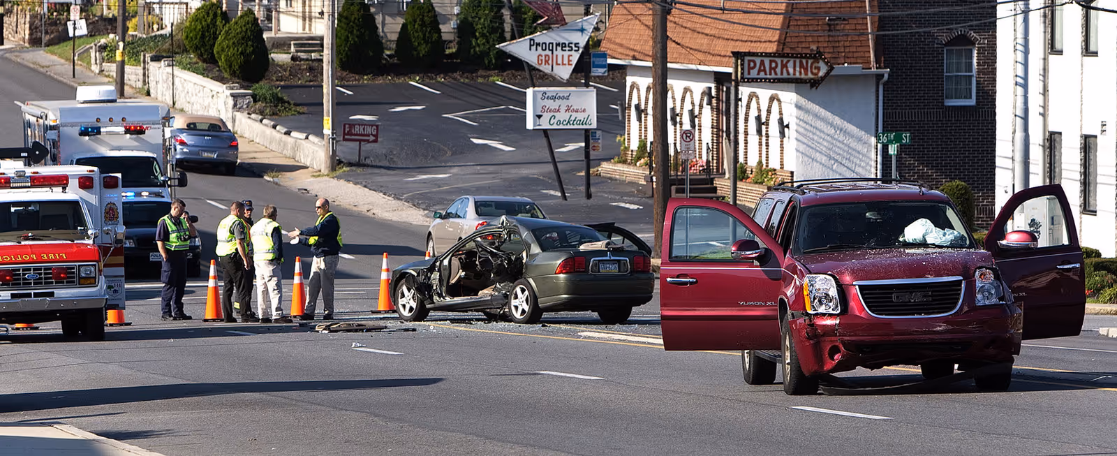 Emergency responders manage a multi-vehicle crash on a city street.