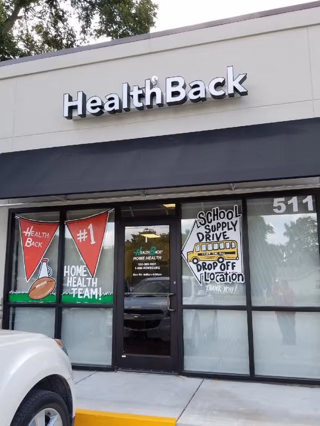 Exterior storefront with HealthBack sign and promotional banners in windows.